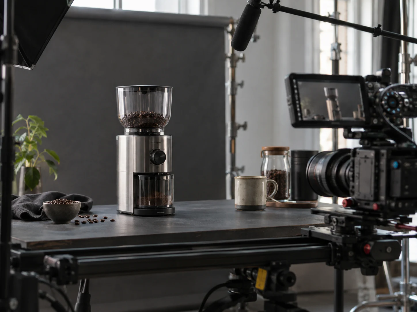 A coffee grinder product advertisement being filmed on a real camera slider